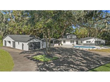 Aerial view of house, pool, and detached garage at 18101 Mason Smith Rd, Brooksville, FL 34604