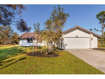 Charming single-story home with a white exterior at 5036 Ivy Ct, North Port, FL 34287