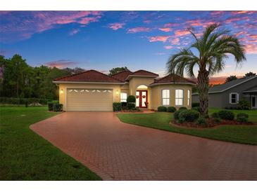 Single-Gathering home with brick driveway and palm tree at 9312 Gentle Ben Ct, Weeki Wachee, FL 34613