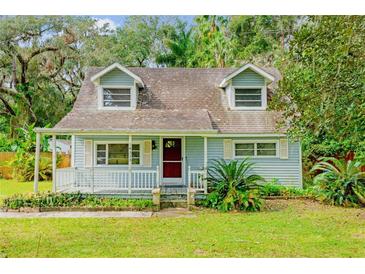 Light blue house with white porch at 14335 Snow Memorial Hwy, Brooksville, FL 34601