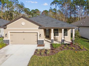 Charming single-story home with a manicured lawn, neutral paint, and stone accents on the porch and garage at 11512 Weaver Hollow Rd, New Port Richey, FL 34654