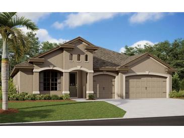 Tan two-story house with a three-car garage and landscaped lawn at 11313 Limpkin Rd, Weeki Wachee, FL 34614