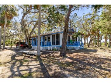 Charming waterfront cottage nestled on a shaded lot with mature trees at 8812 Camp Ln, Hudson, FL 34667
