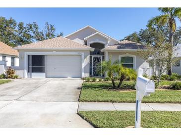 Charming one-story home with a two-car garage and well-manicured lawn at 13215 Golf Ridge Pl, Hudson, FL 34669