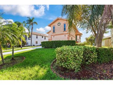 Two-story house with manicured lawn and hedges at 6310 Garland Ct, New Port Richey, FL 34652