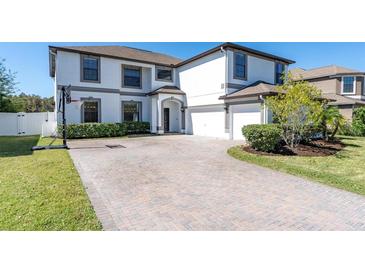 Two-story house with a brick driveway and basketball hoop at 12135 Crestridge Loop, Trinity, FL 34655