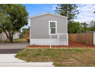 Charming single story home featuring a gray exterior, complemented by a well-maintained lawn at 4304 Buena Vista Ln, Holiday, FL 34691
