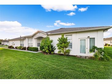 Charming single-story home with well-maintained lawn and garden in a quiet neighborhood setting at 1931 Sassafras Dr, Wesley Chapel, FL 33543