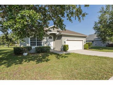Charming single-story home featuring a well-manicured lawn, two-car garage, and welcoming curb appeal at 2293 Dog Leg Ct, Brooksville, FL 34604