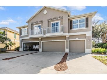 Three-story building with attached garages and balconies at 7650 Red Mill Cir, New Port Richey, FL 34653