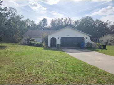 Ranch-style home with attached garage and large yard at 12266 Birch St, Brooksville, FL 34613
