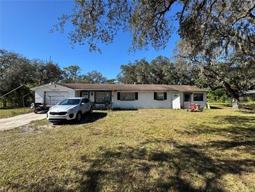 Ranch-style home with a carport and spacious yard at 12635 Colony Rd, Hudson, FL 34669