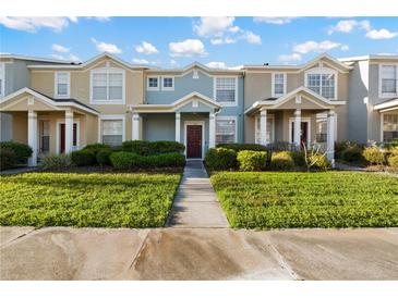 Daytime view of charming two-story townhome with landscaped yard at 3411 Broken Bow Dr, Land O Lakes, FL 34639