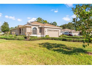 Single-story home with a two-car garage and well-maintained lawn at 4201 Silver Berry Ct, Spring Hill, FL 34609