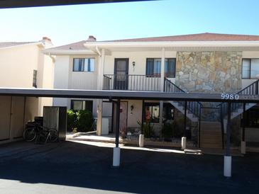 Condo building with carport and stairs leading to entrance at 9980 Eagles Point Cir # 3, Port Richey, FL 34668