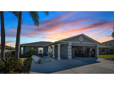 Nice curb appeal, single-story home with a two-car garage and a boat at 13610 Evelane Dr, Hudson, FL 34667