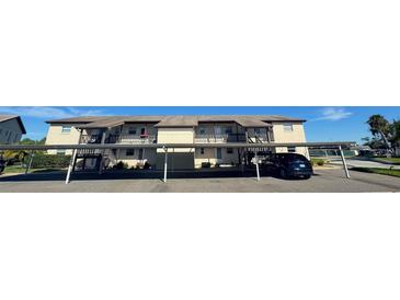 Two-story condo building with covered parking and balconies at 4901 Onyx Ln # 202, New Port Richey, FL 34652