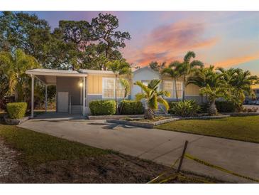 Inviting exterior of a single-story home with landscaped yard and covered entryway at 4620 Tri Par Dr, Sarasota, FL 34234