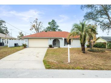 Charming single story home with a one car garage and well maintained lawn at 2027 Beckwith Ave, Spring Hill, FL 34608