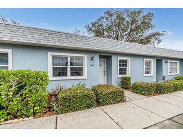 Inviting light blue exterior condo with well-manicured landscaping at 3644 Trophy Blvd, New Port Richey, FL 34655