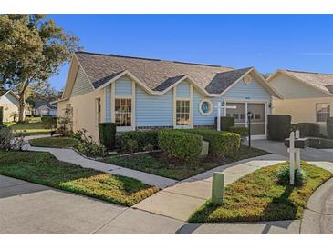 Cute light blue exterior, two-car garage, and well-manicured landscaping at 4808 Vesper Ct, New Port Richey, FL 34655