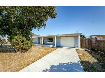 Charming single-story home featuring a well-maintained lawn, driveway, and a welcoming front porch at 3444 Clydesdale Dr, Holiday, FL 34691