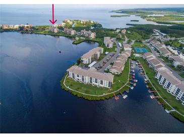 Aerial view of waterfront condo community with pool and boat slips at 4550 Bay Blvd # 1237, Port Richey, FL 34668