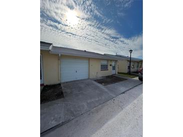 Ranch style home with attached garage and driveway at 4942 Hazner St, New Port Richey, FL 34652
