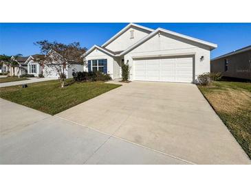 Charming one-story home featuring a well-manicured lawn and a two-car garage at 3337 Autumn Amber Dr, Spring Hill, FL 34609