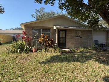 Ranch style home with landscaped yard and mature trees at 6825 Lingo Ct, New Port Richey, FL 34653