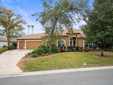 House exterior showcasing landscaping and a three-car garage at 8480 Athens Ct, Weeki Wachee, FL 34613