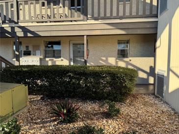 Condo building exterior with entrance and landscaping at 4829 Onyx Ln # 102, New Port Richey, FL 34652
