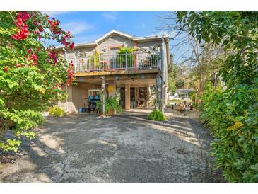 Unique elevated home with a carport and an inviting front balcony area at 8142 River Point Dr, Weeki Wachee, FL 34607