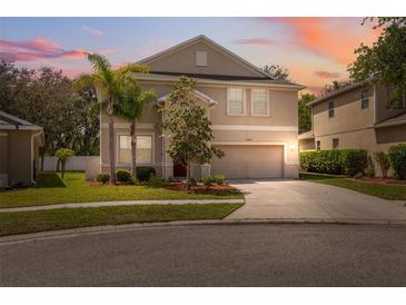 Charming two-story home with a well-manicured lawn and lovely landscaping at 12307 Duckett Ct, Spring Hill, FL 34610