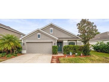Charming single-Gathering home with a well-manicured lawn and attached two-car garage at 14284 Finsbury Dr, Spring Hill, FL 34609