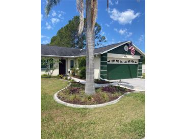 Charming single-story home featuring a landscaped front yard and an attached two-car garage at 4649 Westerly Dr, New Port Richey, FL 34653