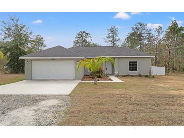 Charming single-story home features a well-maintained lawn, attached two-car garage and freshly painted exterior at 13094 Tailorbird Ave, Brooksville, FL 34614