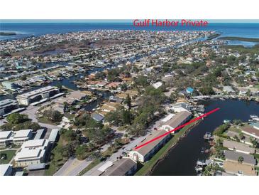 This aerial showcases the waterfront property with private canal access and stunning Gulf Harbor views at 4533 Marine Pkwy # 206, New Port Richey, FL 34652