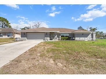 Charming single-story home with a well-maintained lawn and attached two-car garage, perfect for suburban living at 13419 Banner Rd, Spring Hill, FL 34609