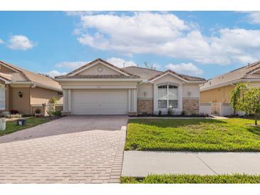 Charming one-story home with a brick driveway and well-maintained landscaping at 4412 Caliquen Dr, Brooksville, FL 34604