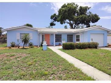 Charming, light blue single-story home with well-manicured lawn and inviting pathway to the front door at 5830 34Th N Ave, St Petersburg, FL 33710