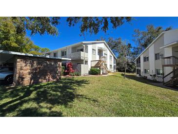 Charming two-story condo with beautiful landscaping and exterior staircases, offering a welcoming curb appeal at 12406 Eagleswood Dr # B, Hudson, FL 34667