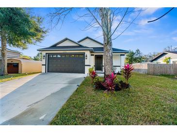Charming single-Gathering home boasts a well-manicured lawn and a two-car garage at 12706 N Ola Ave, Tampa, FL 33612