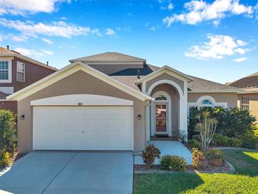 Charming single-Gathering home featuring a two-car garage and well-maintained landscaping at 1801 Loch Haven Ct, Trinity, FL 34655