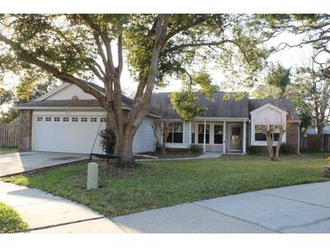 Charming single-story home with a well-maintained lawn and mature landscaping at 2233 Egret Walk Ct, New Port Richey, FL 34655