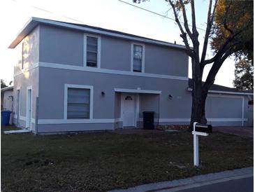 Two-story home featuring a gray exterior, white trim, front yard, and a mailbox at 3801 Kimball Ave, Tampa, FL 33614