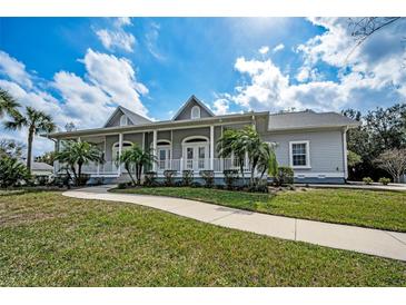 Charming single-story home with a welcoming front porch and well-manicured lawn at 5050 Limestone Dr, Port Richey, FL 34668