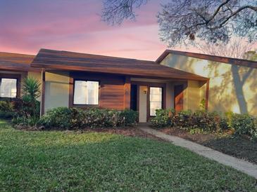 Cozy single-story home featuring a manicured lawn and mature landscaping, offering comfortable suburban living at 7523 Greystone Dr # 35, Hudson, FL 34667