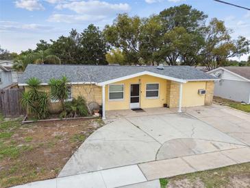 Charming single-story home with a well-maintained lawn and a spacious driveway at 7427 Congress St, New Port Richey, FL 34653