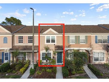 Townhome featuring a well-maintained facade and landscaped front yard at 6027 Bayside Key Dr, Tampa, FL 33615